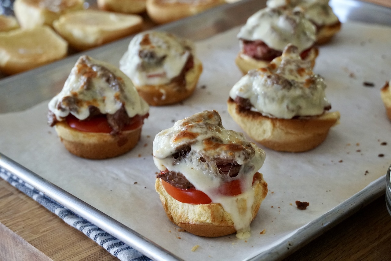 The grilled steak sliders after the cheese has been melted.