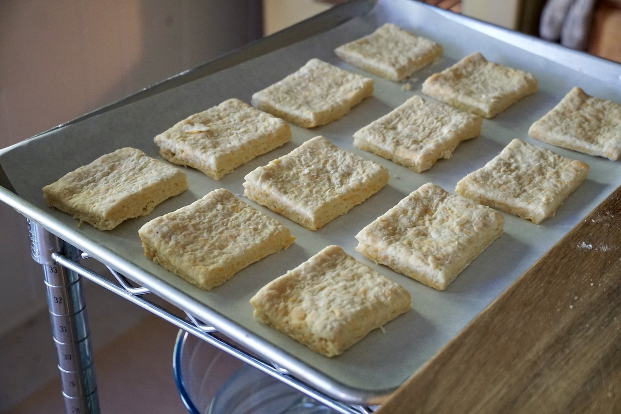 A parchment-lined baking tray filled with the raw biscuits, ready to be baked.