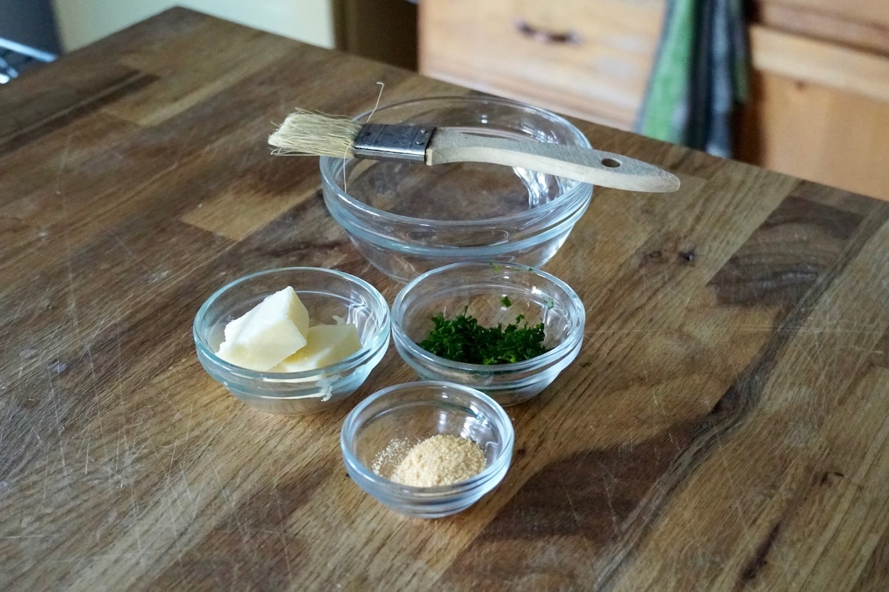 Bowls containing the ingredients for a garlic butter glaze.