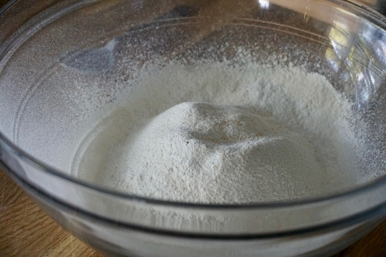 A large bowl containing the flour mixture after being sifted.