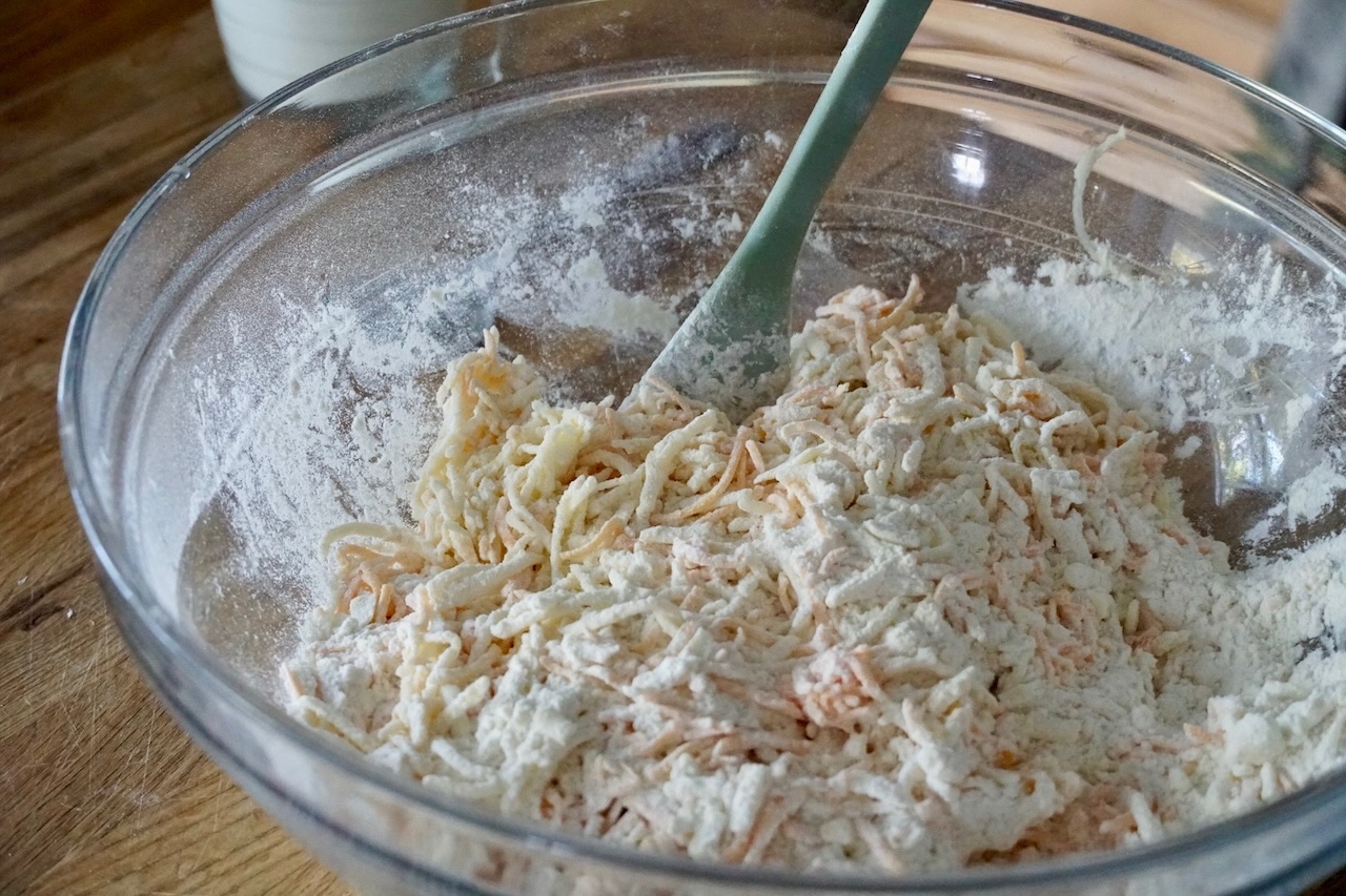 The dry mixture stirred together with butter, grated apple and grated Canadian cheddar cheese.