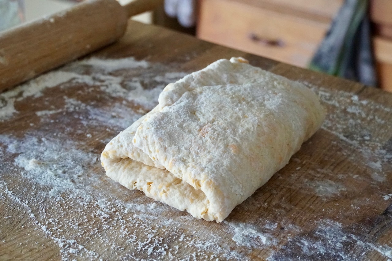 The biscuit dough shaped and folded in thirds ready to be rolled.