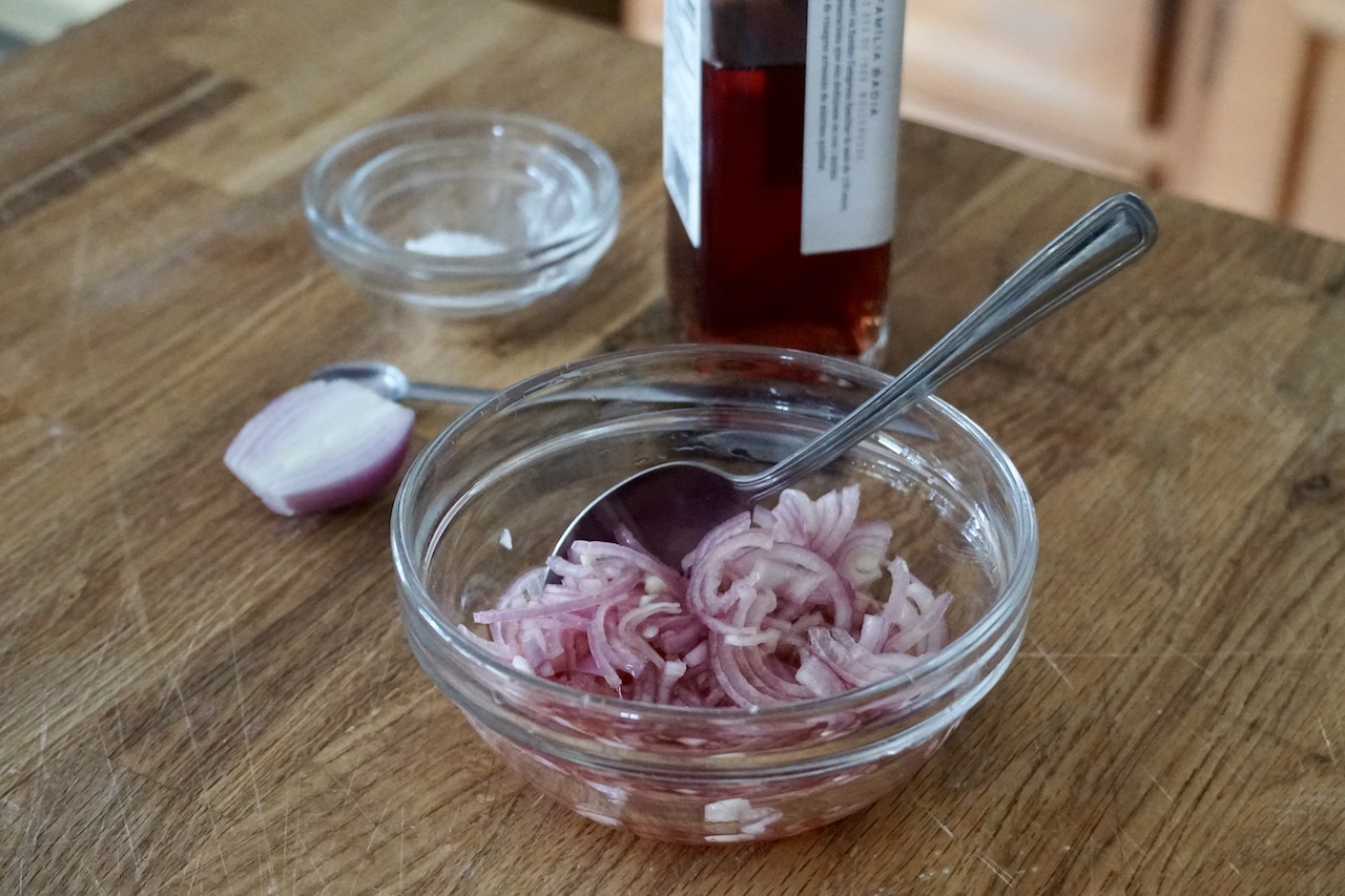 Thinly sliced shallots tossed in red wine vinegar and a bit of kosher salt.