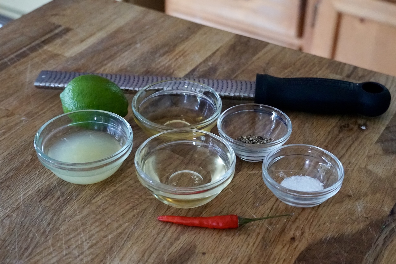 All of the ingredients needed to make the honey-lime vinaigrette.