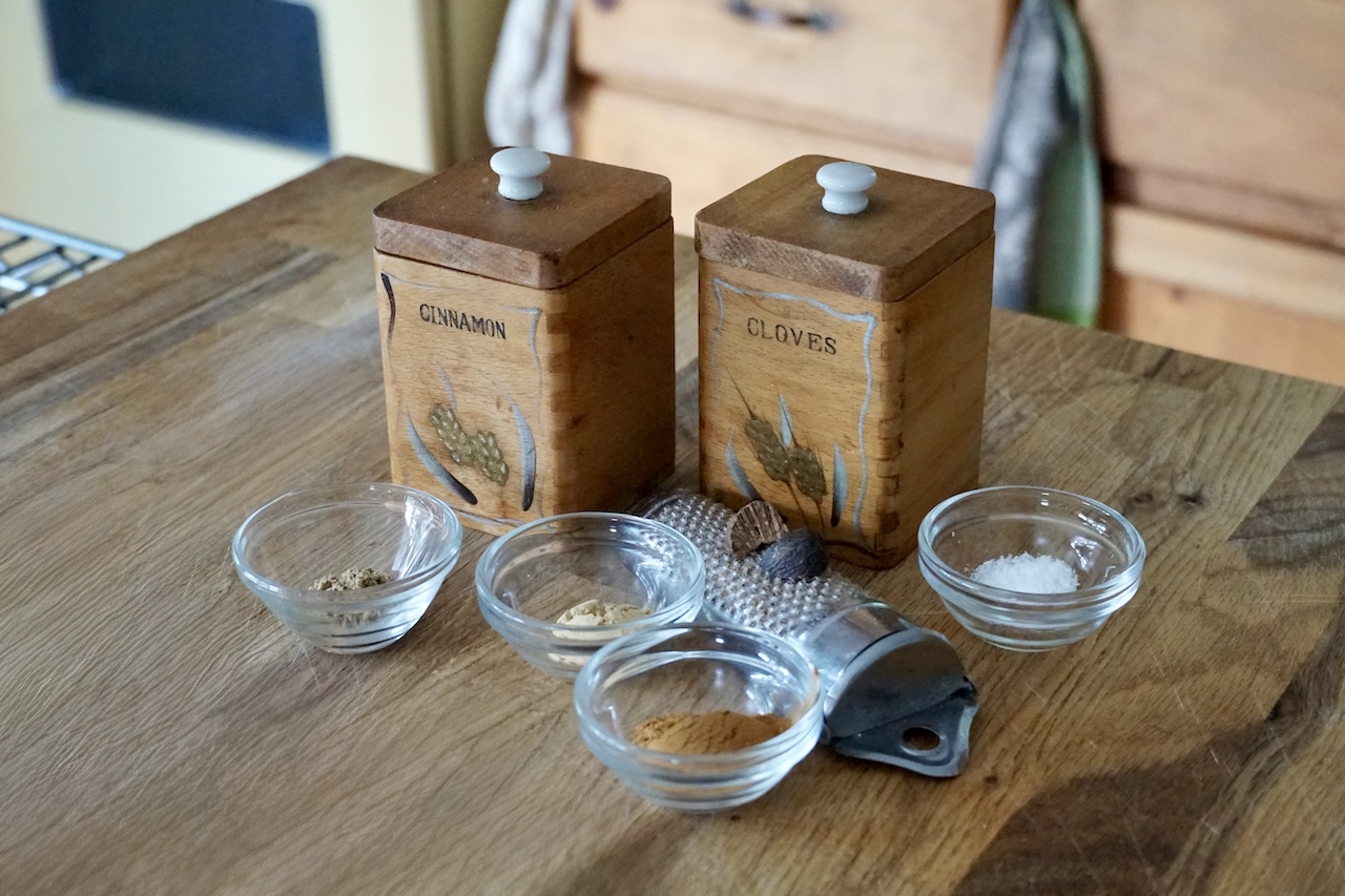 Assorted spices in small bowls including: cinnamon, ginger, coriander and kosher salt.