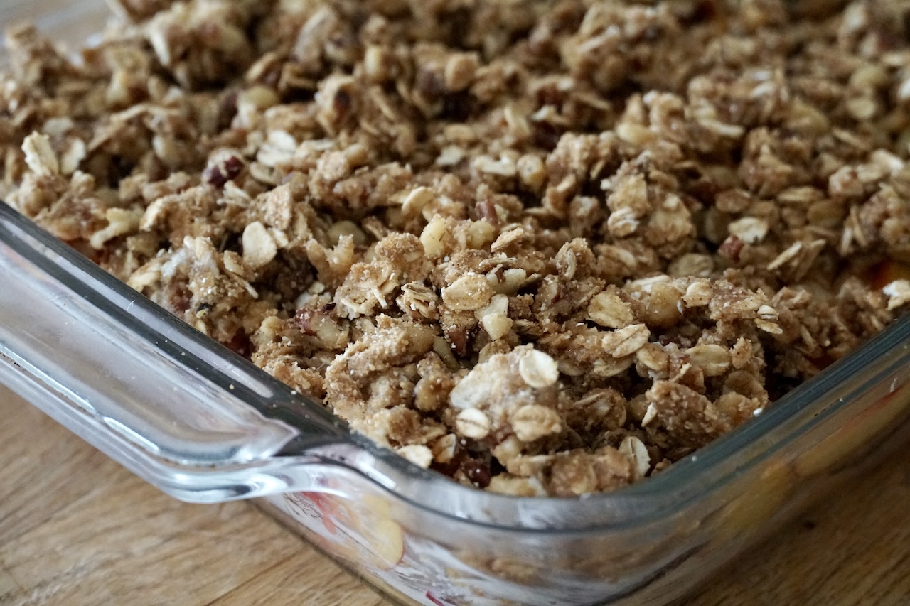 The fresh fruit mixture tossed with the crumbly crisp topping mixture.