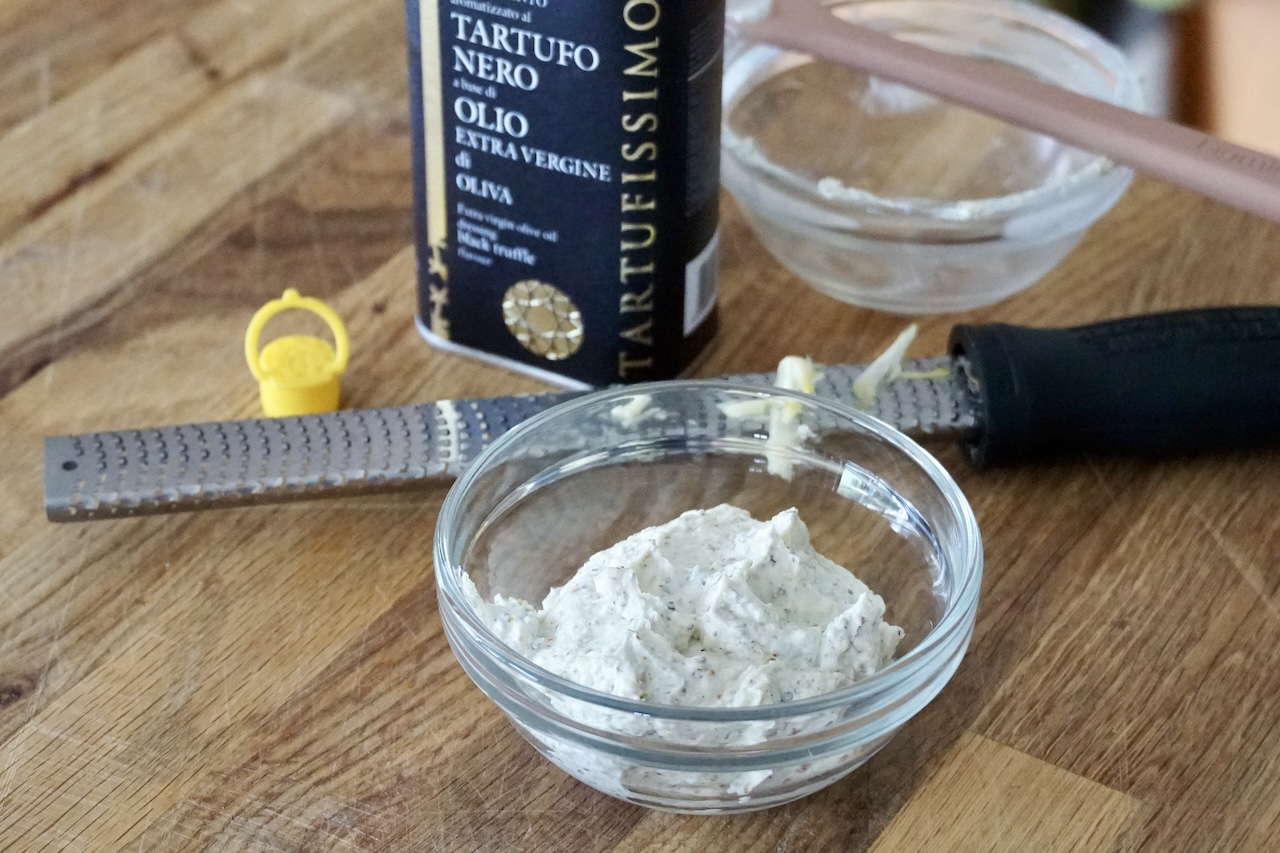 A bowl of the herbed cream cheese.