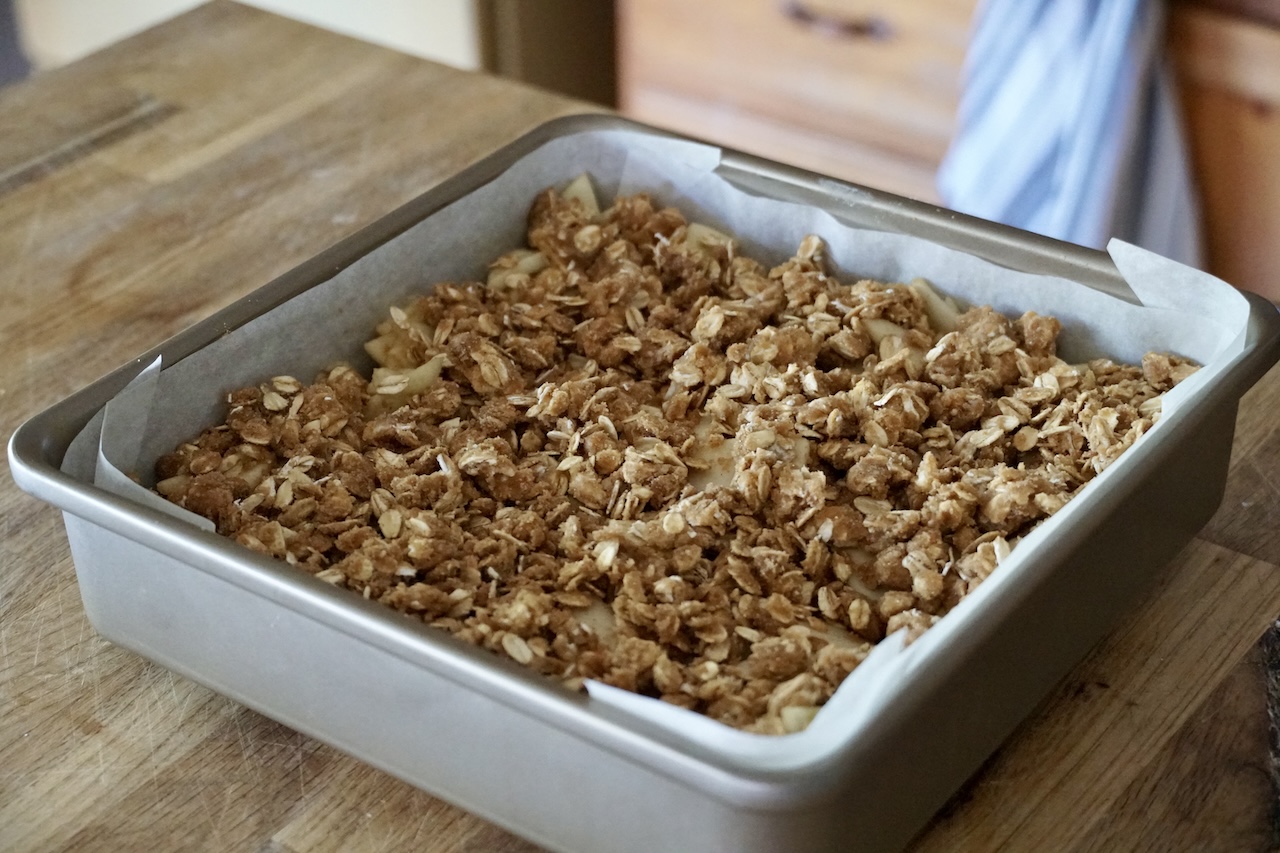 The apple dessert topped with the crumbled crisp topping.