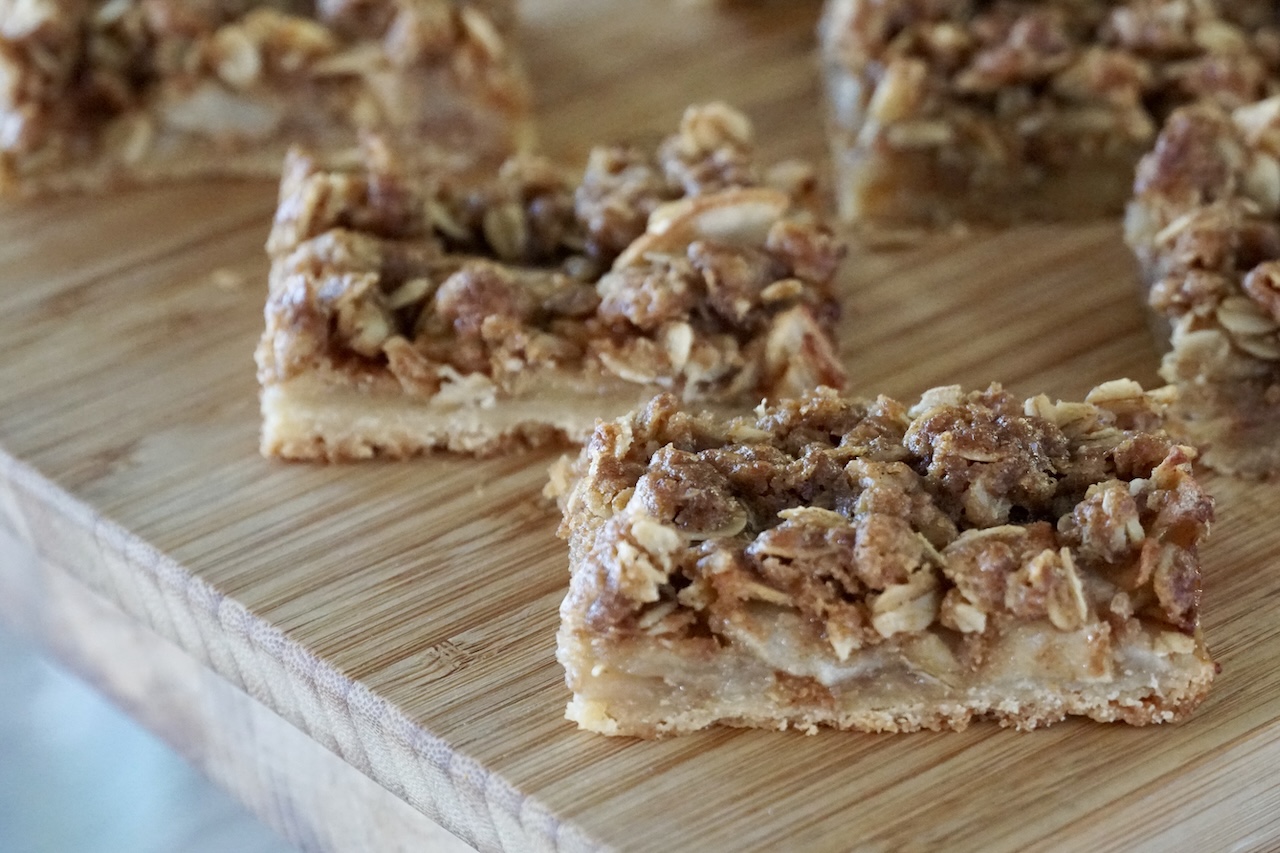 The crumble bars laid out on a wooden cutting board.