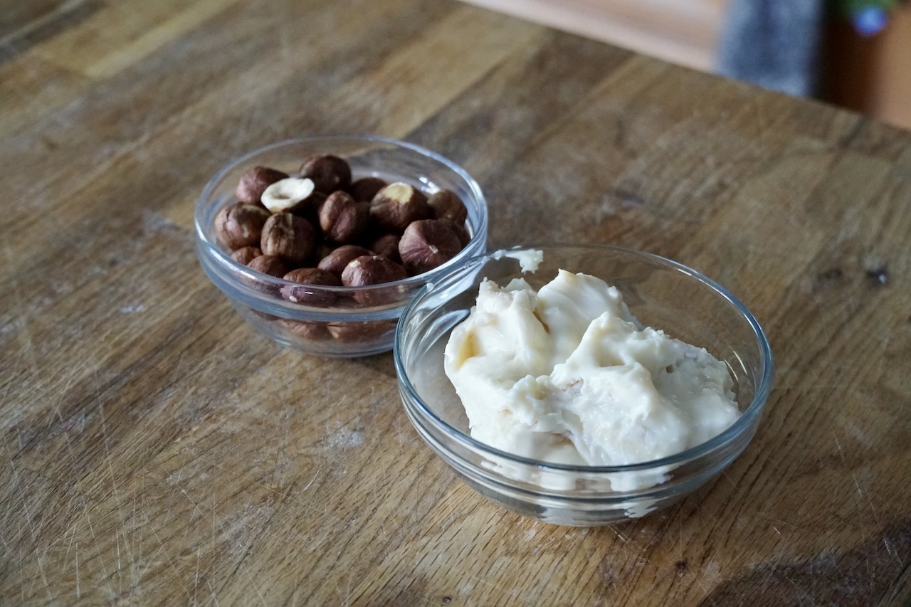 A bowl of toasted hazelnuts and creamy gorgonzola cheese.
