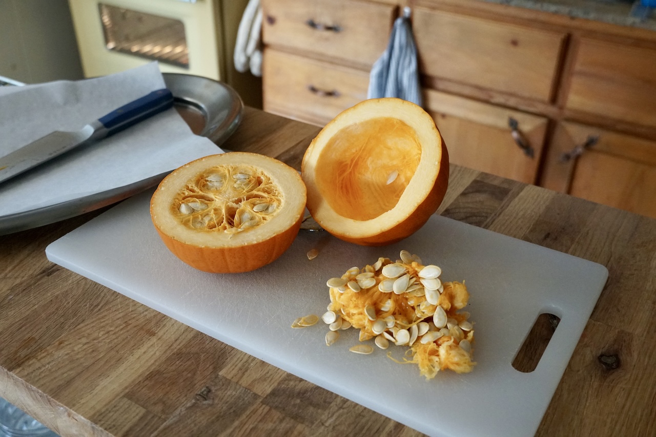 A sugar pumpkin cut in half.