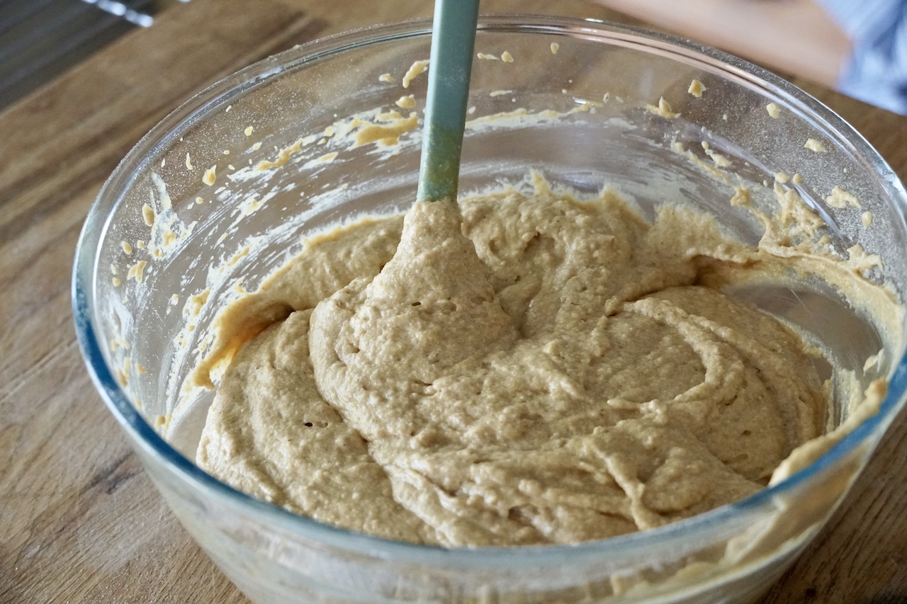 The spiced pumpkin cake batter stirred up in a large bowl.