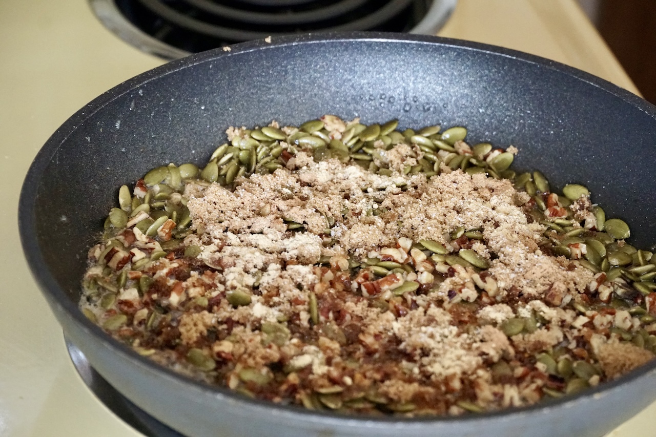 The topping ingredients cooking in a large skillet on stovetop.