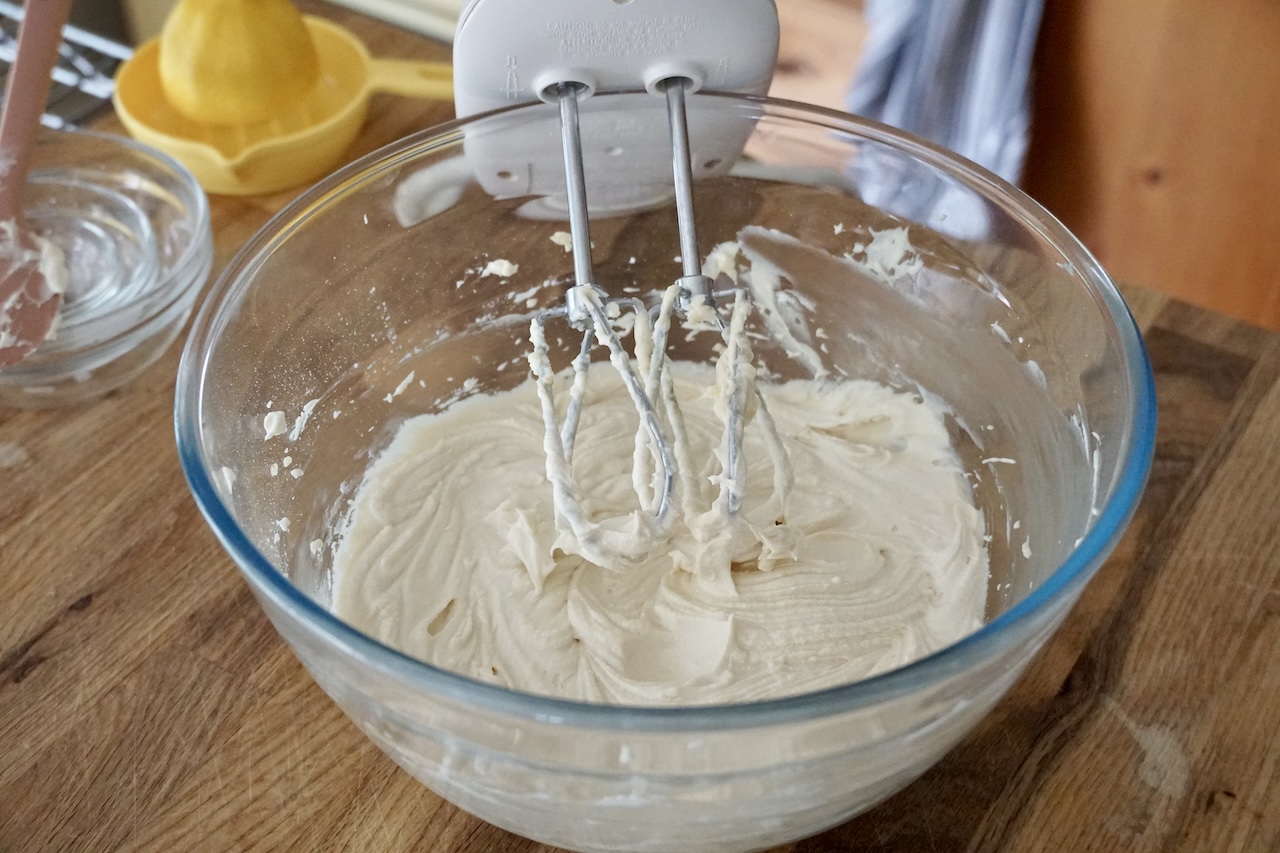 The lemony cream cheese icing whipped up in a large bowl.