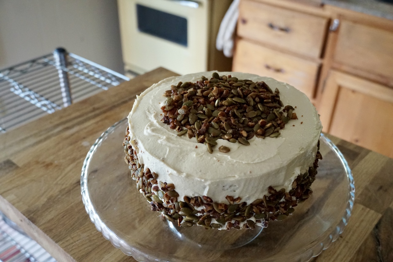 The spiced pumpkin cake assembled on a footed cake stand.