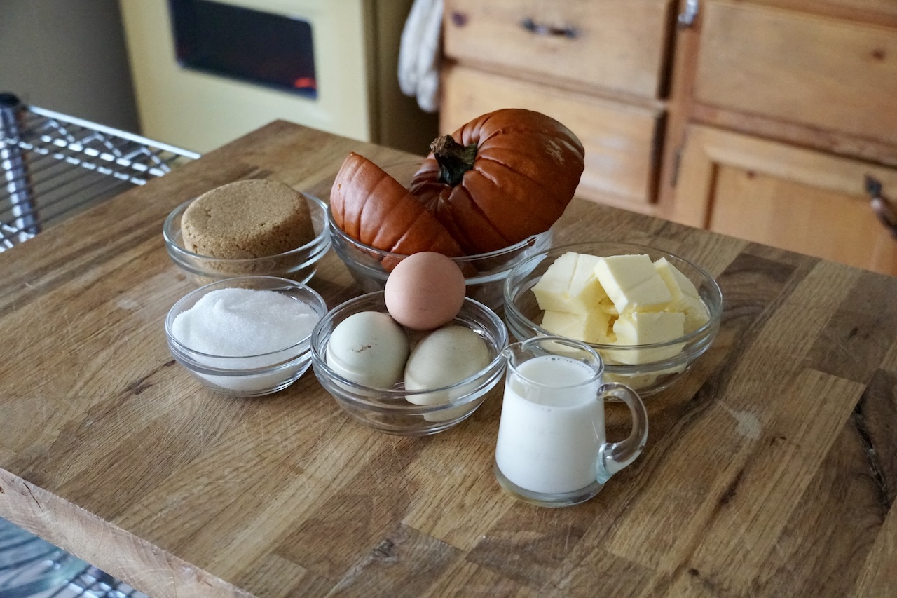 The wet ingredients for the pumpkin spice cake assembled in small glass bowls.