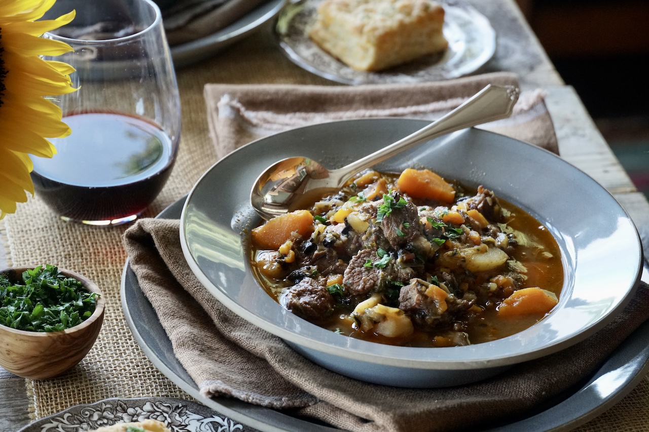 Veal Stew Recipe served with red wine and biscuits.